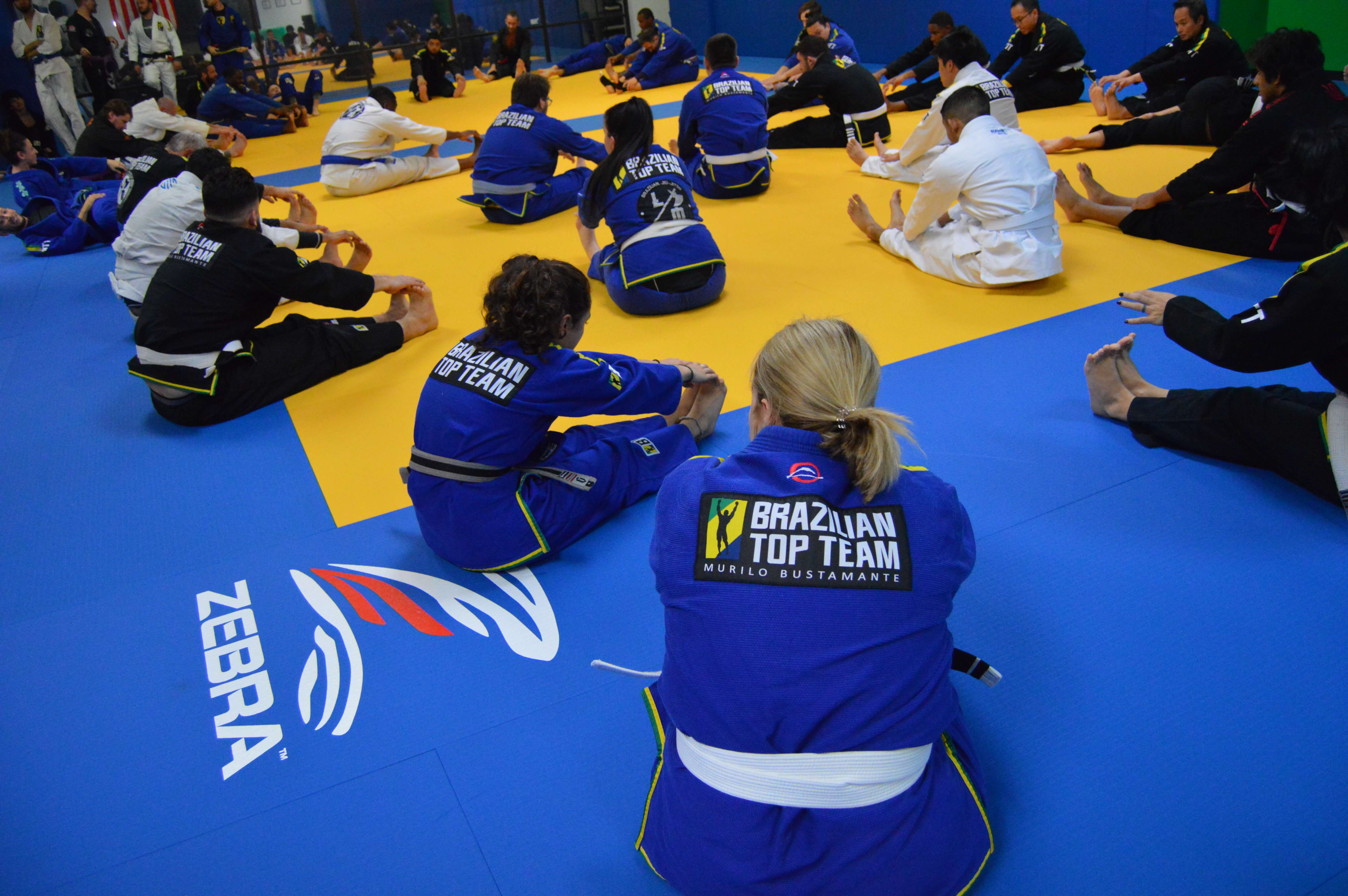 BTT North Dallas class stretching together on the mat